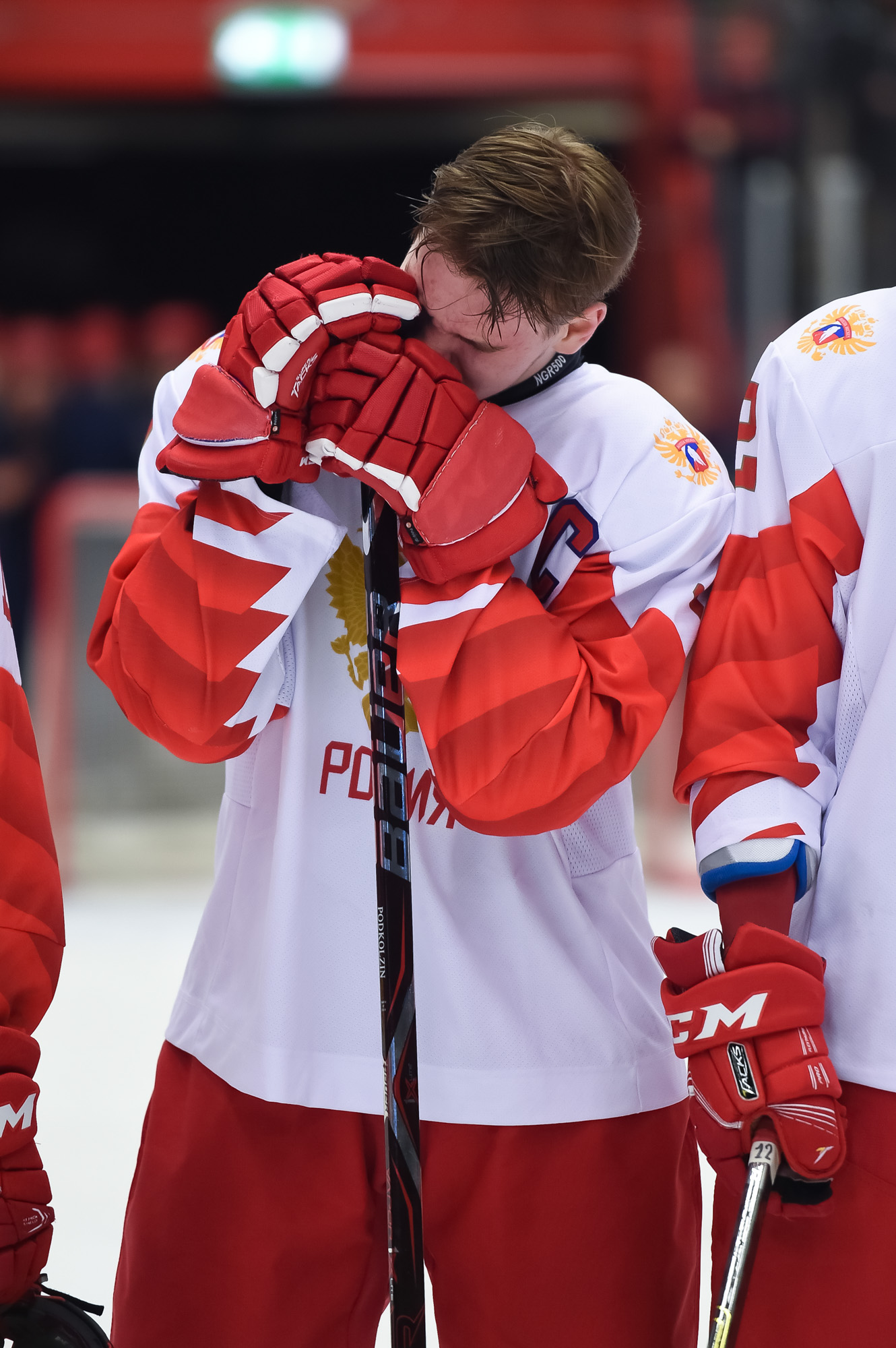 Sweden's Lucas Raymond sits on the bench with a broken tooth after a  collision during the group A match between Sweden and United States at the  ice hockey world championship in Tampere