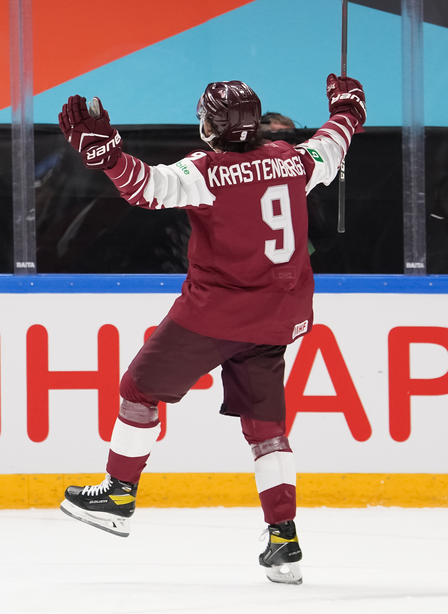 United States Cutter Gauthier (19) falls to the ice chasing the puck near  Latvia's Rudolfs Balcers (21) in their bronze medal match at the Ice Hockey  World Championship in Tampere, Finland, Sunday