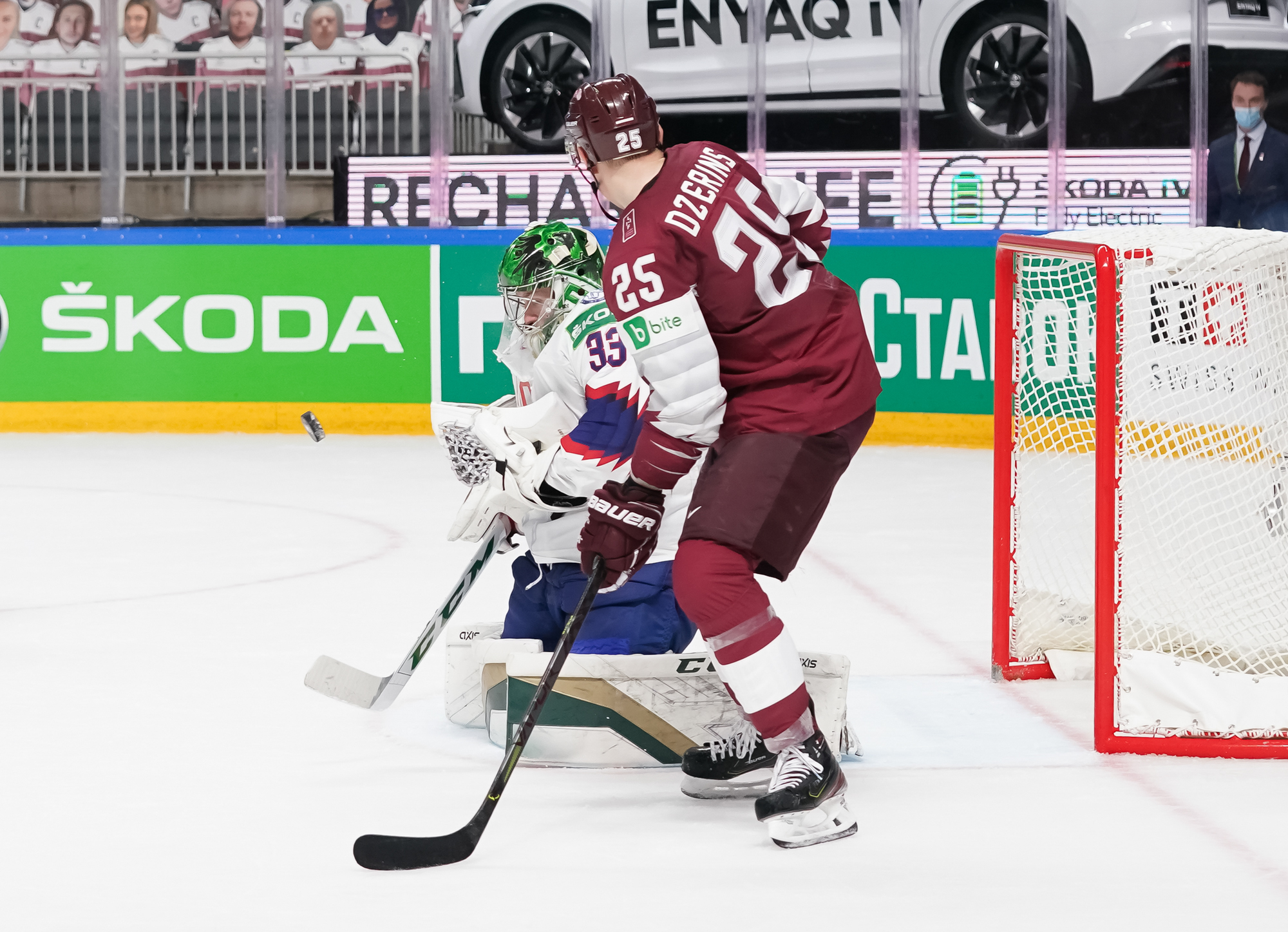 United States Cutter Gauthier (19) falls to the ice chasing the puck near  Latvia's Rudolfs Balcers (21) in their bronze medal match at the Ice Hockey  World Championship in Tampere, Finland, Sunday